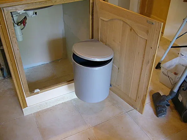 Vide-ordure installé Vide-ordure fixé à la porte du caisson sous évier